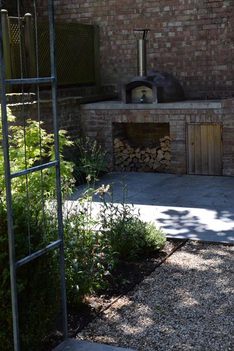 Wood fired oven and log storage